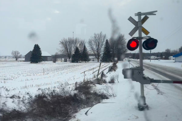 A snowy rural landscape with a train crossing signal showing red lights, symbolizing transitions and pauses, reflecting the introduction's theme of shifting environments and decision-making. A snowy rural landscape with a train crossing signal showing red lights, symbolizing transitions and pauses, reflecting the introduction's theme of shifting environments and decision-making.