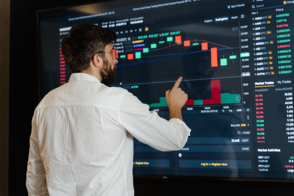 An executive analyzing charts and graphs on a big screen, highlighting the importance of data-driven decision-making for leaders. An executive analyzing charts and graphs on a big screen, highlighting the importance of data-driven decision-making for leaders.