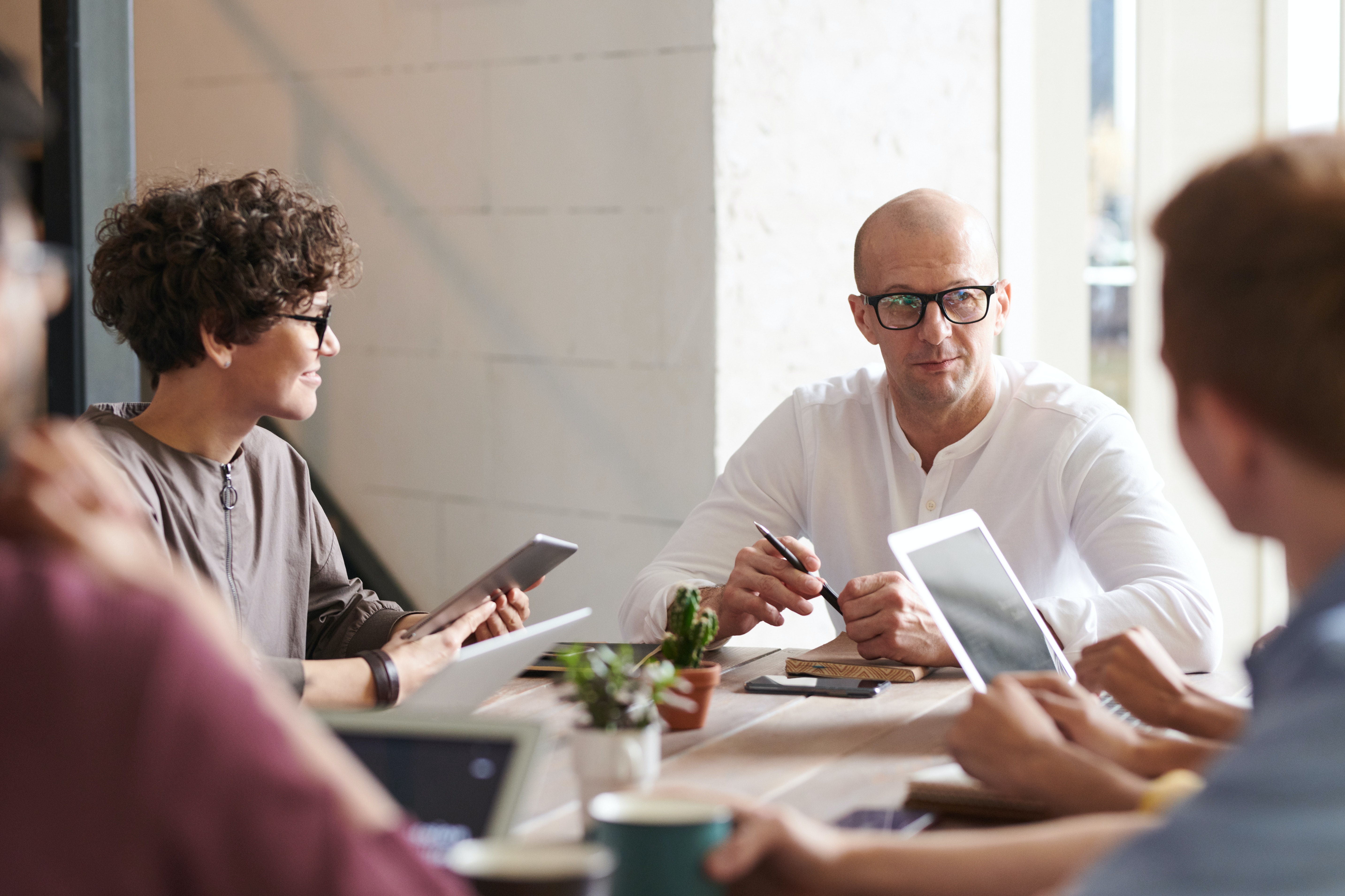 A few people meeting together at a meeting table