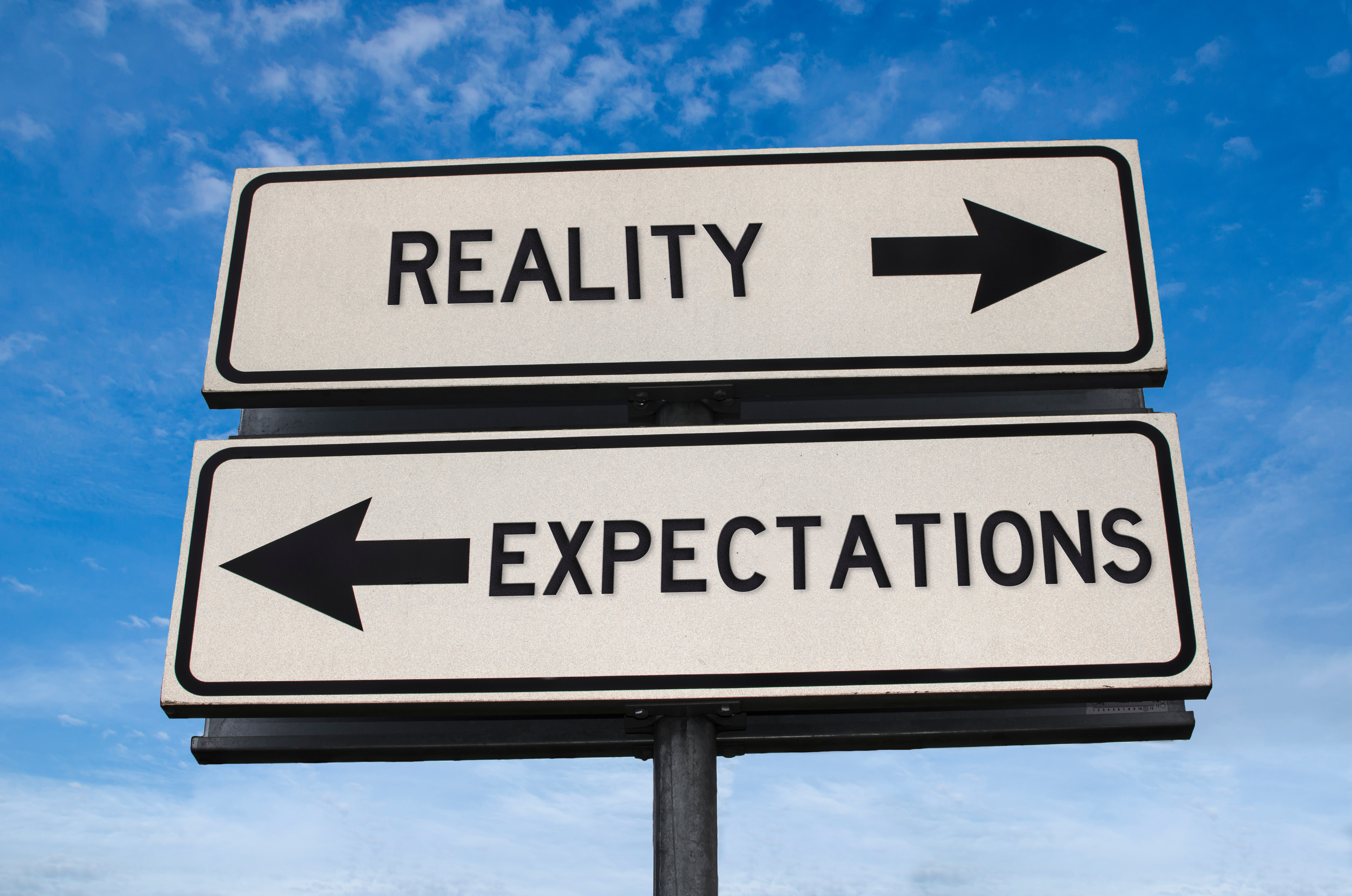 Street signs that say Reality vs Expectation