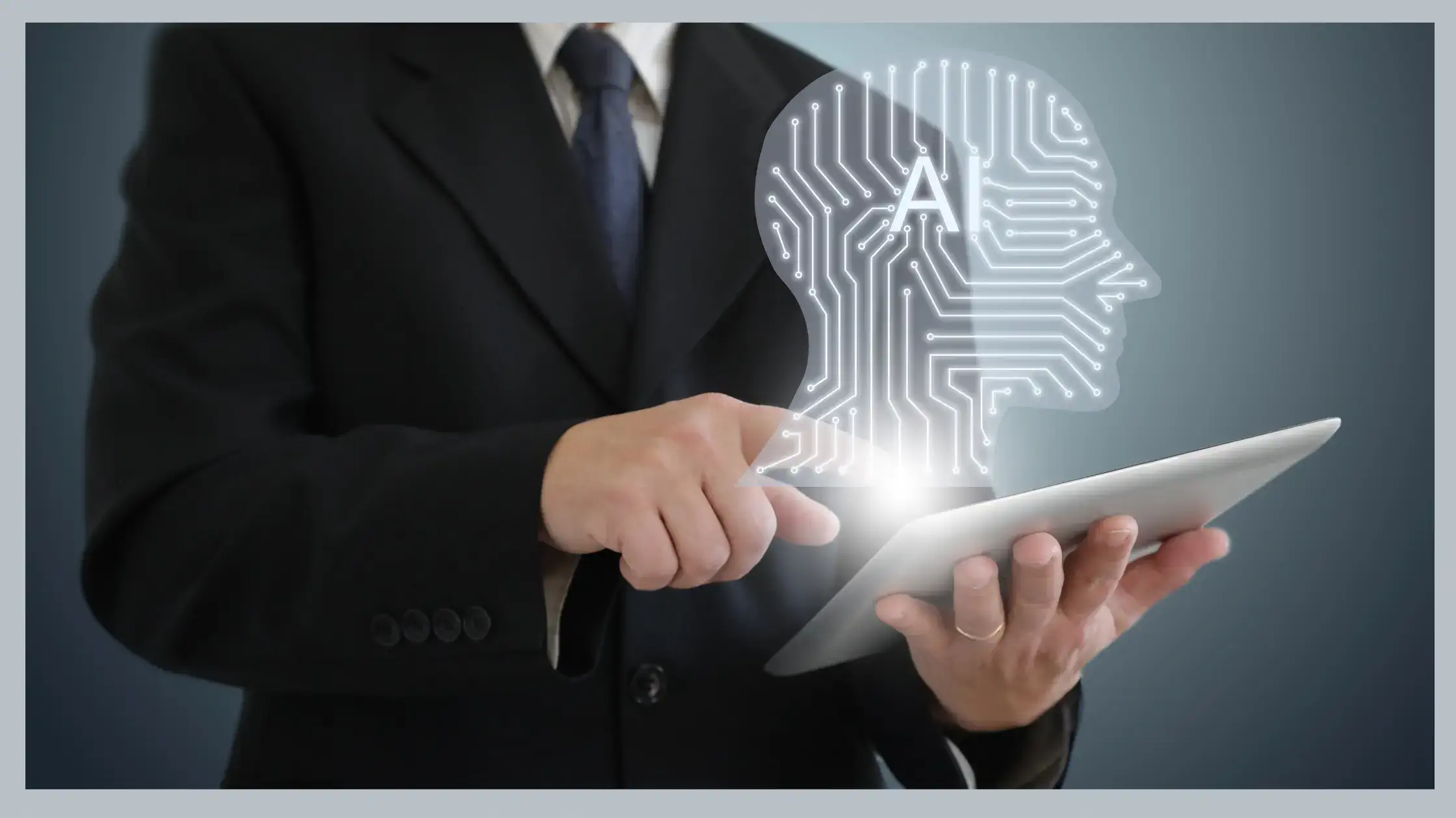 Business man in a suit holding a laptop computer with a white digital human head poping out of the computer - in the middle of the head is the letters AI