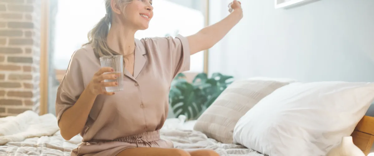 Woman stretching happily on bed after weight loss treatment Woman stretching happily on bed after weight loss treatment