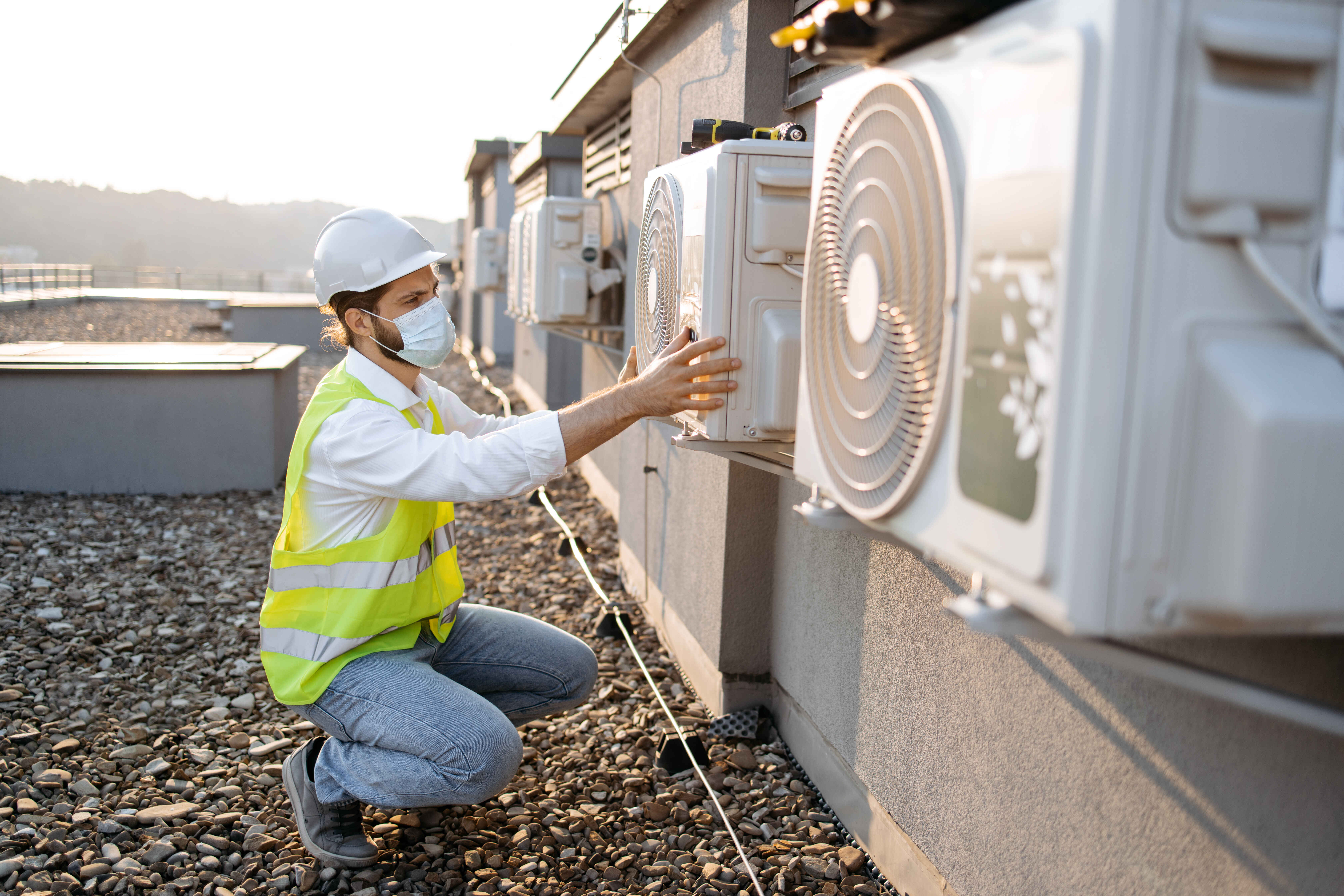 Technician Checking HVAC system for maintenance