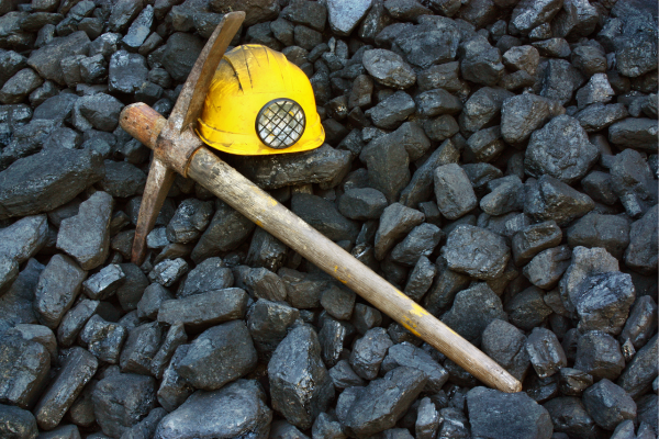 Close-up image of coal chunks symbolizing the legacy of coal mining communities and the importance of tailored retirement and estate planning for their residents.