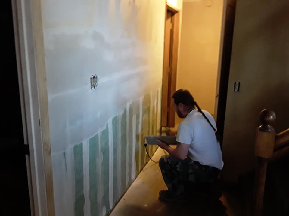 Scott fixing a customer's drywall