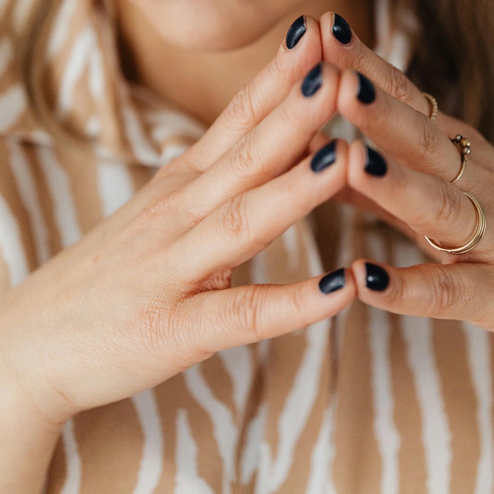 Woman with fingertips touching in steepling hand position