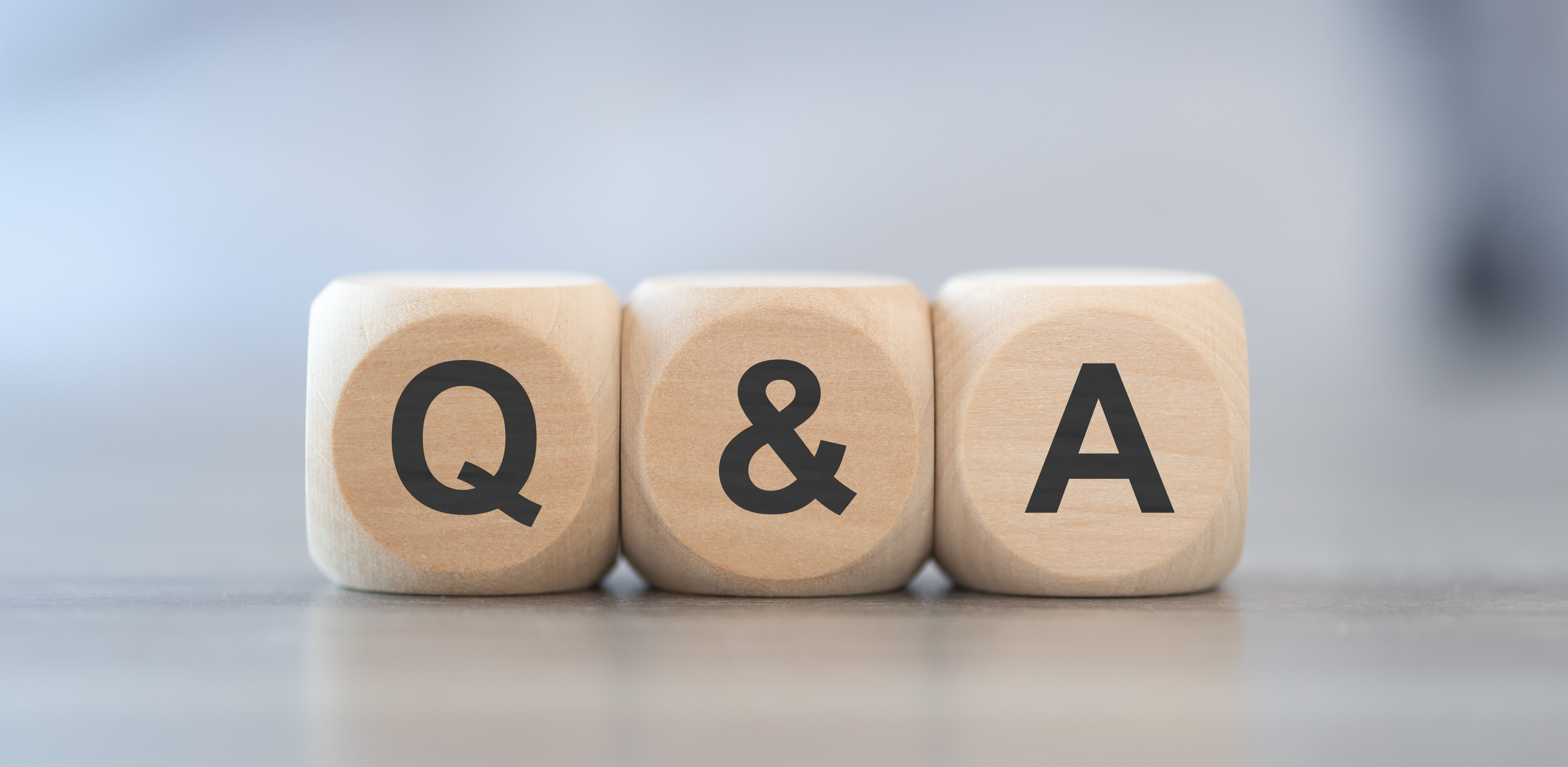 Q and A letters displayed on wooden cubes symbolizing frequently asked questions.