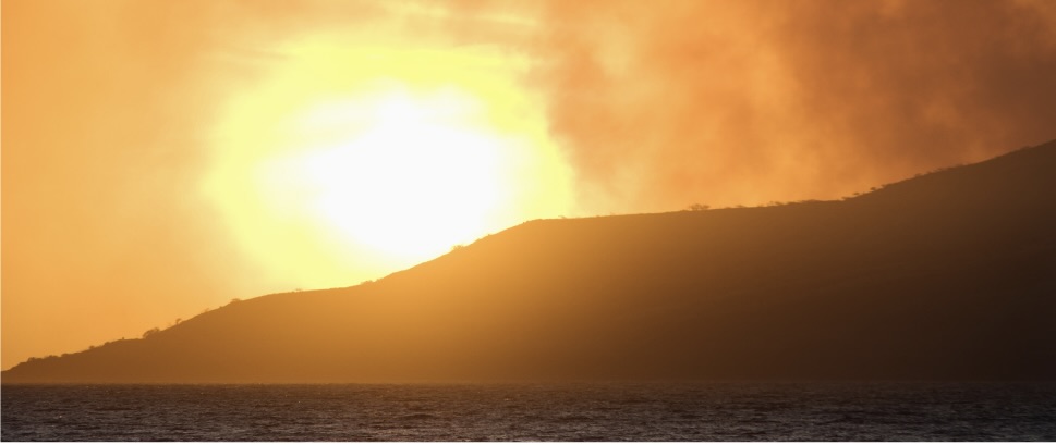 Vibrant sunrise over a Maui mountain ridge.