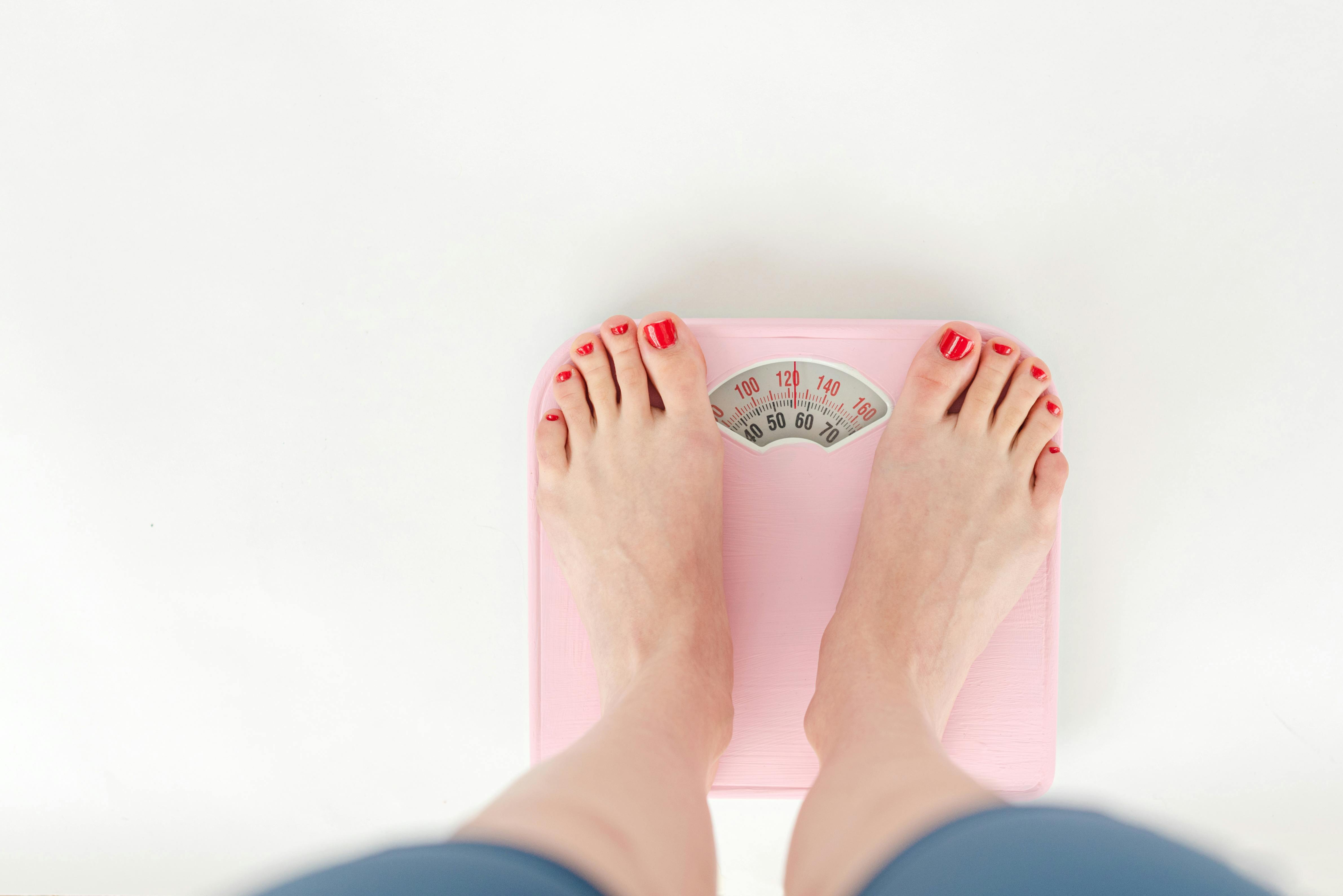A close-up of a scale on a tile floor, symbolizing weight management and health. A close-up of a scale on a tile floor, symbolizing weight management and health.