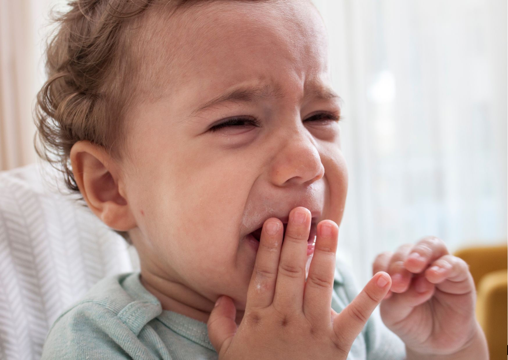 baby with teething pain in crib