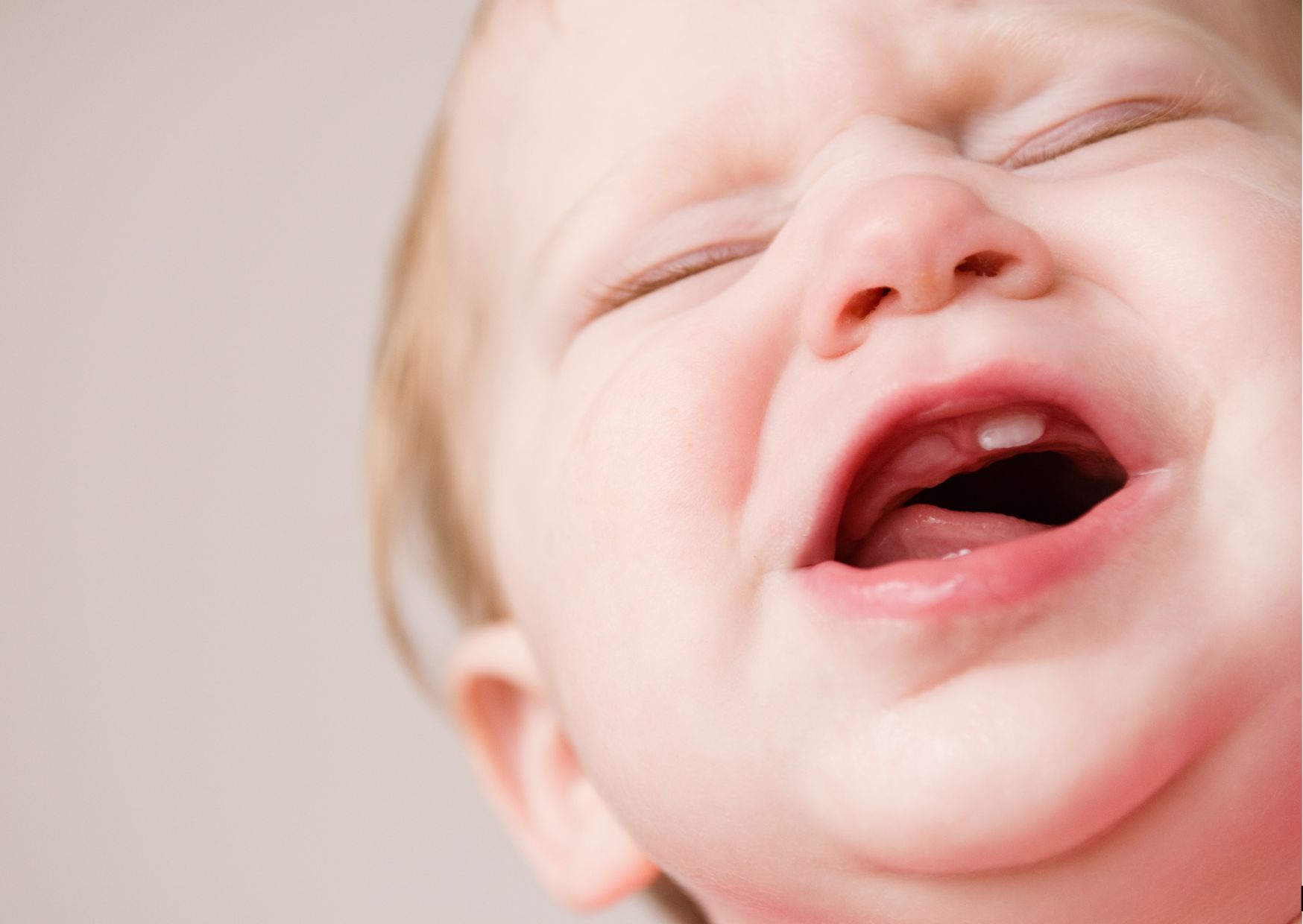 baby crying because new tooth is coming in