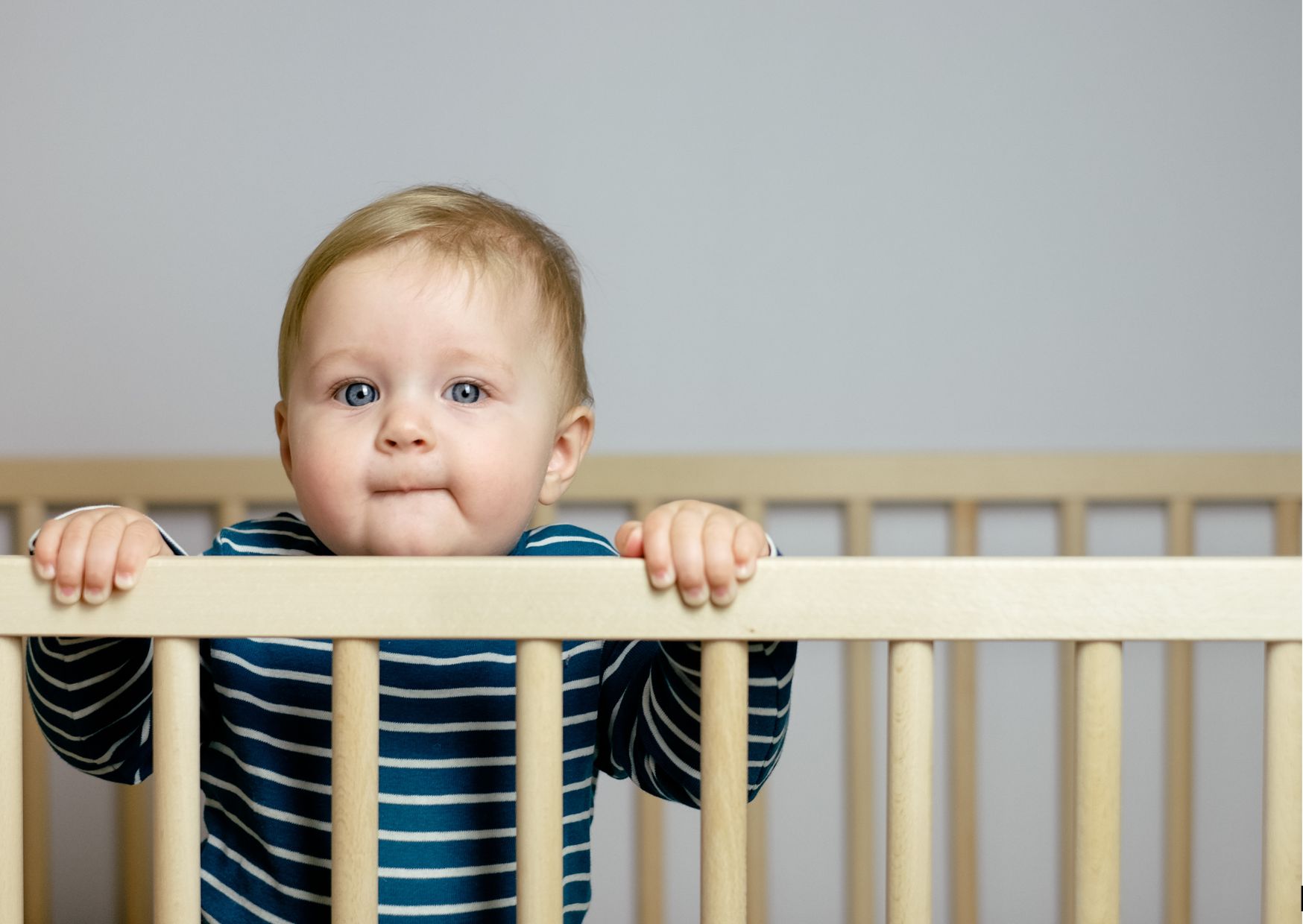baby standing in crib looking for parents at morning time baby standing in crib looking for parents at morning time