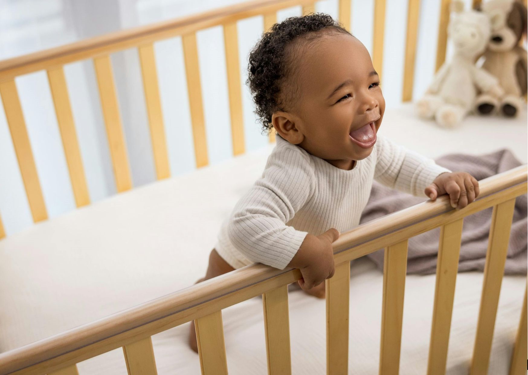 black baby standing in crib and smiling early in the morning before wake up time black baby standing in crib and smiling early in the morning before wake up time
