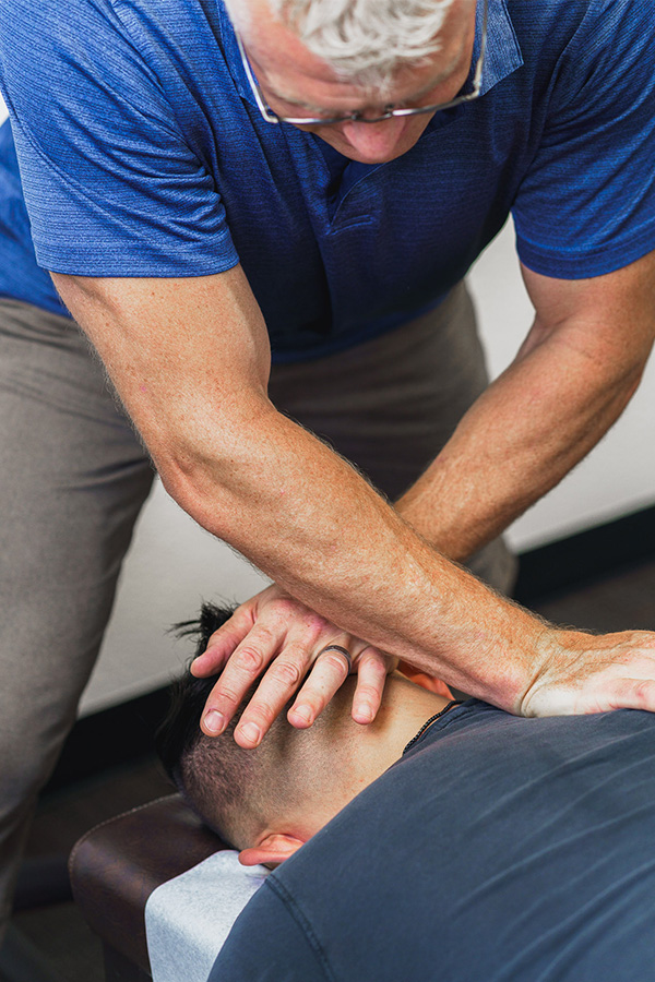 Dr. Andrew Allen helping a chiropractic patient