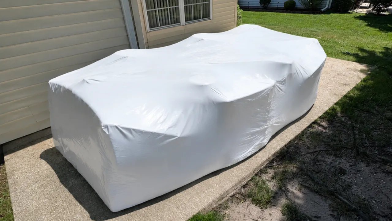 Professional shrink wrapping protecting outdoor furniture for winter in New Jersey