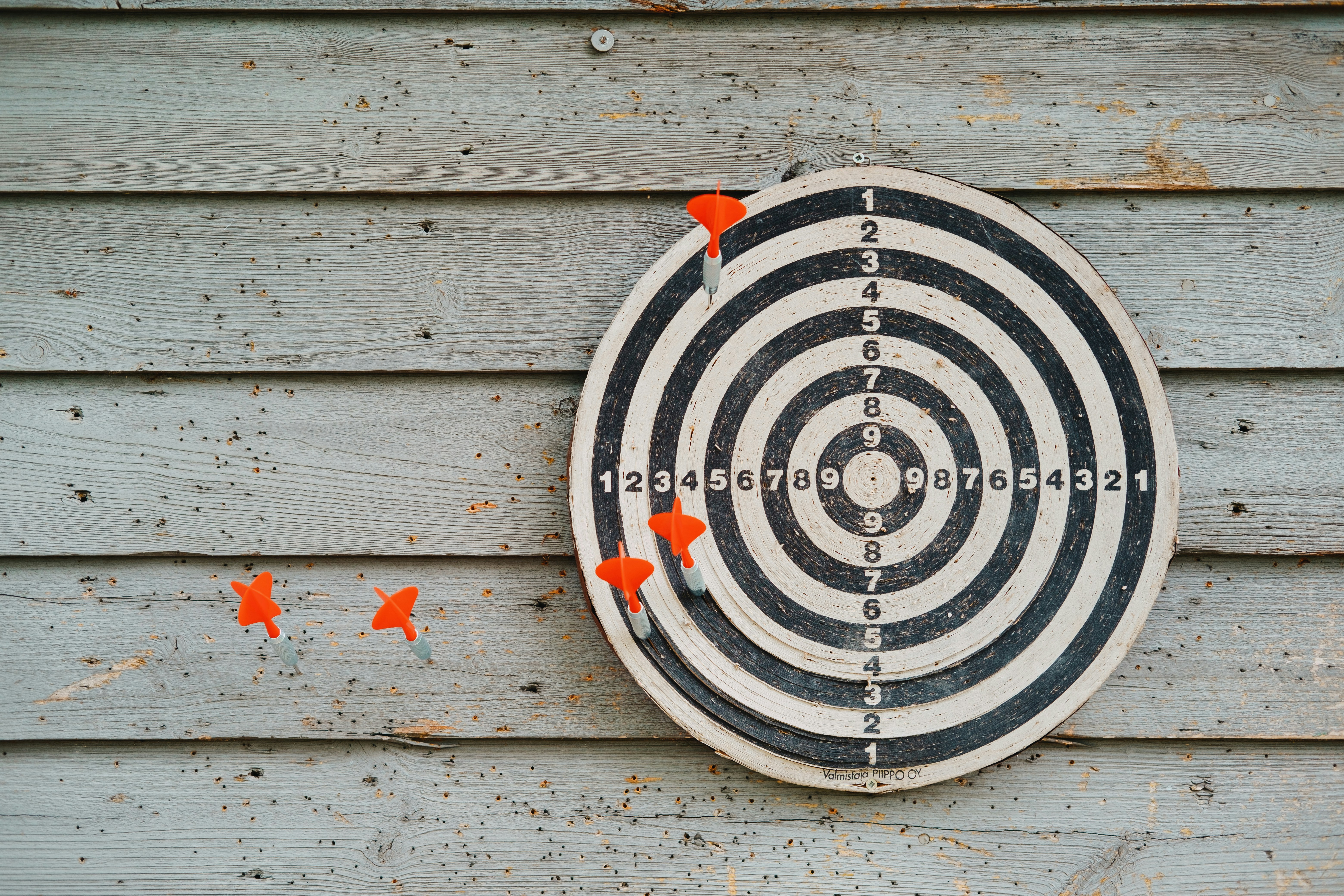 Dartboard representing a business aim to retain customers by putting the darts in to the bullyeye Dartboard representing a business aim to retain customers by putting the darts in to the bullyeye