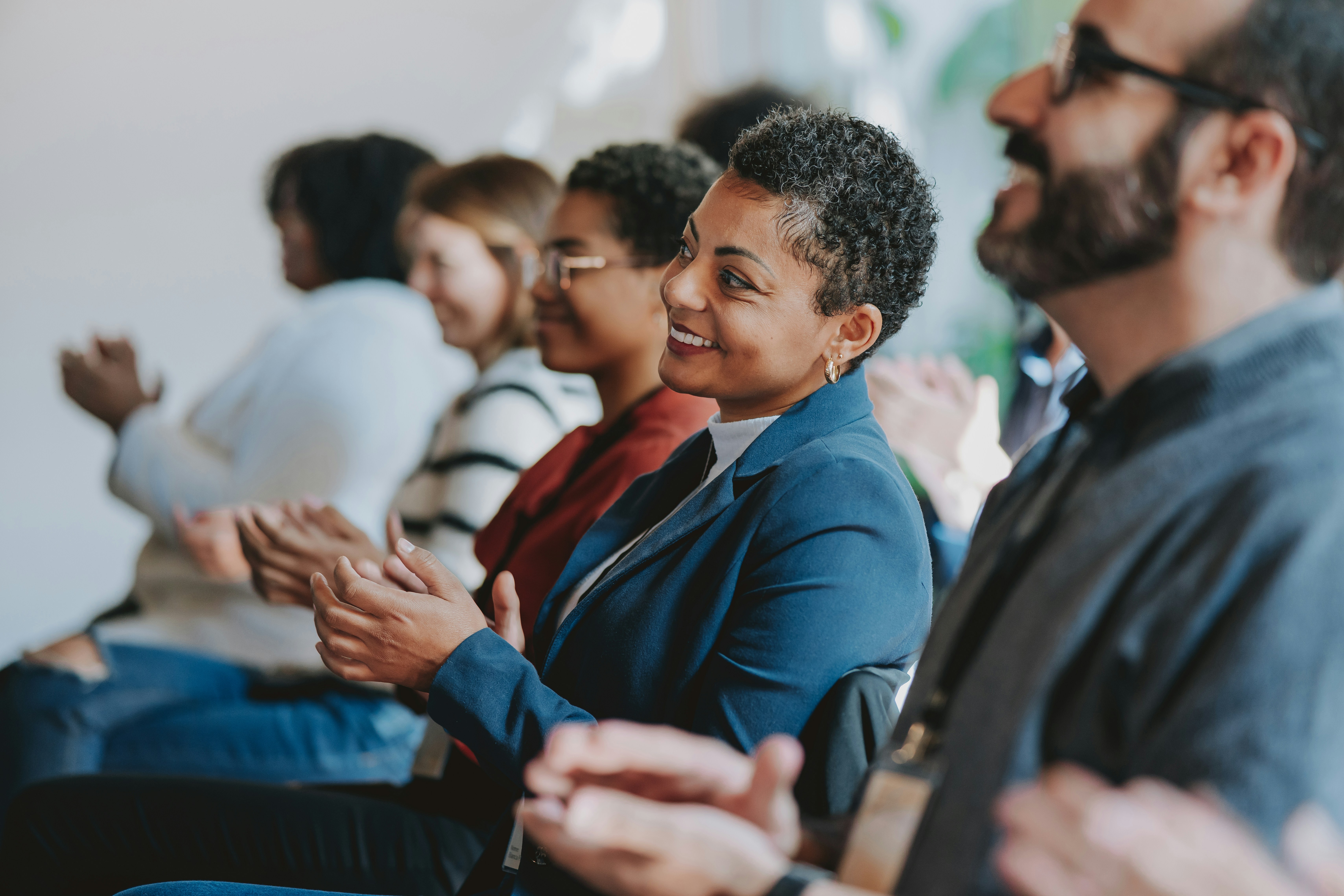 Audience member showing genuine emotional engagement while listening to speaker at business conference