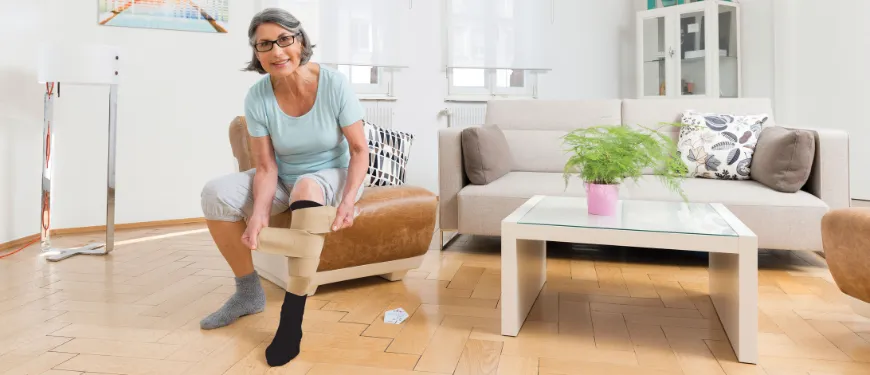 Demonstration of compression stocking application using a donning aid, alongside a medical diagram showing correct leg measurements for proper compression fit.