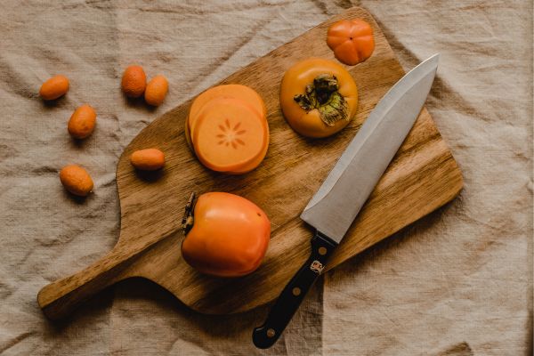 a sliced persimmon on a wooden board a sliced persimmon on a wooden board