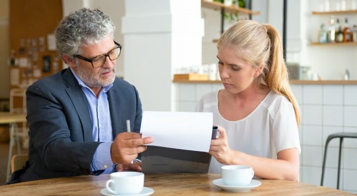 mature advisor helping young woman