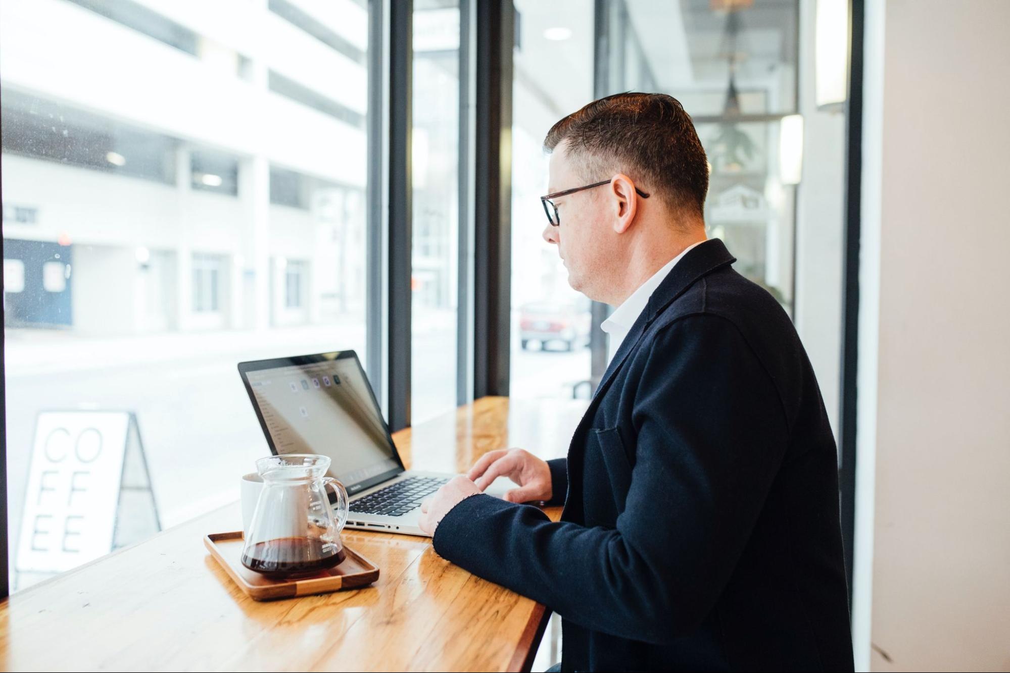 image of man working on his computer