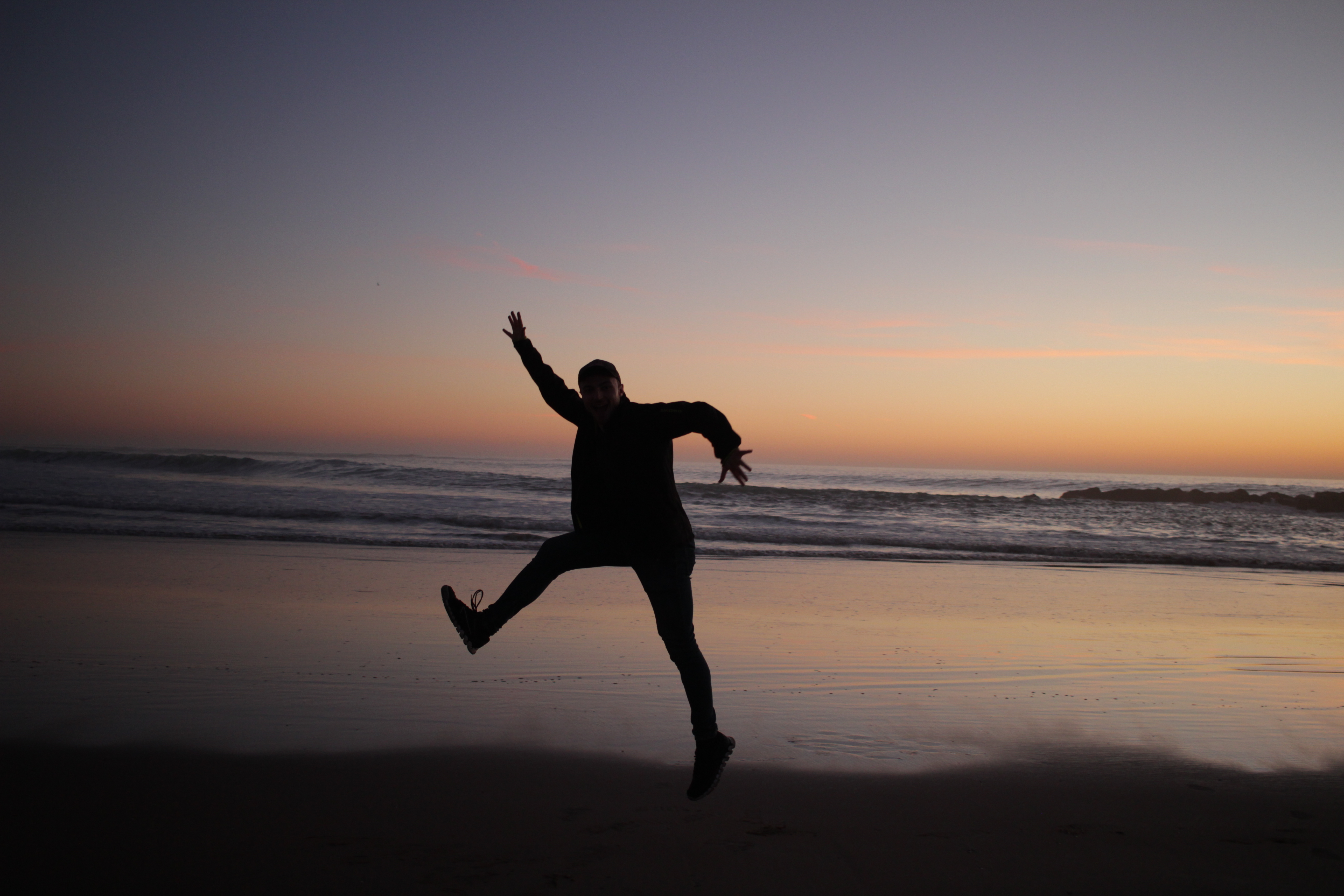 Tobias Katlein jumping on a beach at sunset