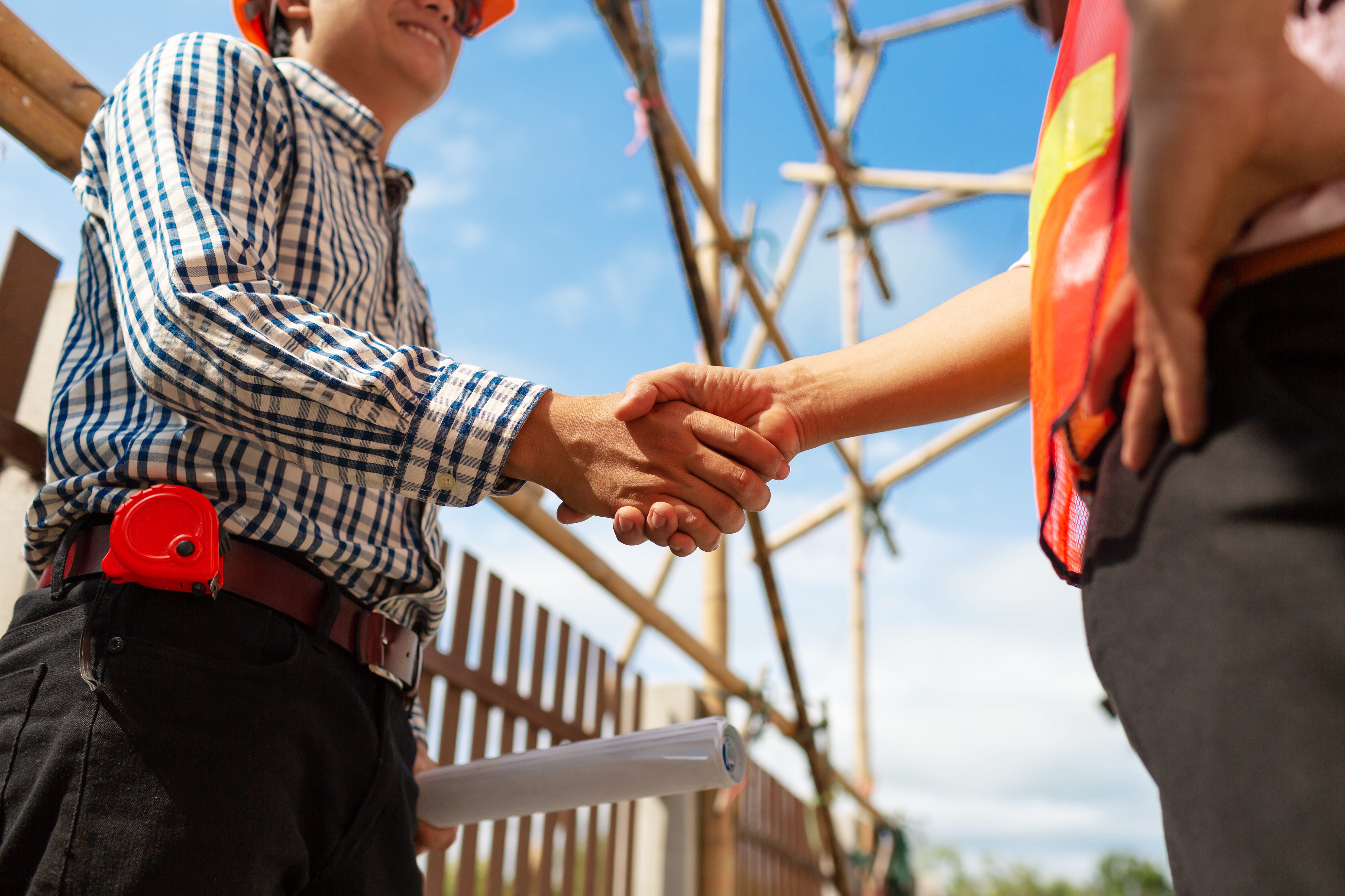 an expert remodeler shaking hands with client