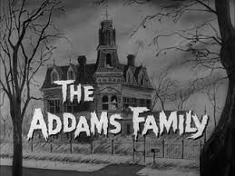 Opening shot of the mansion behind the text The Addams Family from the 1960x