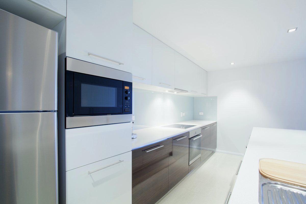 Spacious kitchen with integrated appliances and dining area