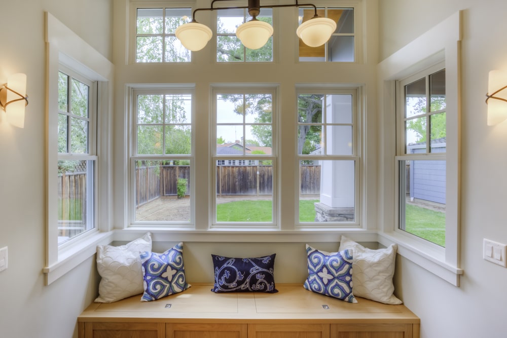 windows and sofa with pillows