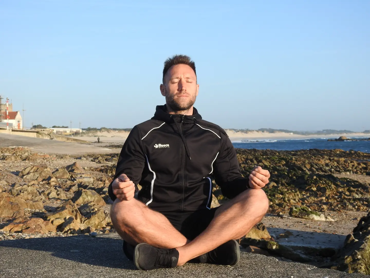A serene image depicting a balanced lifestyle: a person practicing yoga outdoors with a backdrop of nature, symbolizing harmony between physical health, mental well-being, and a peaceful environment.