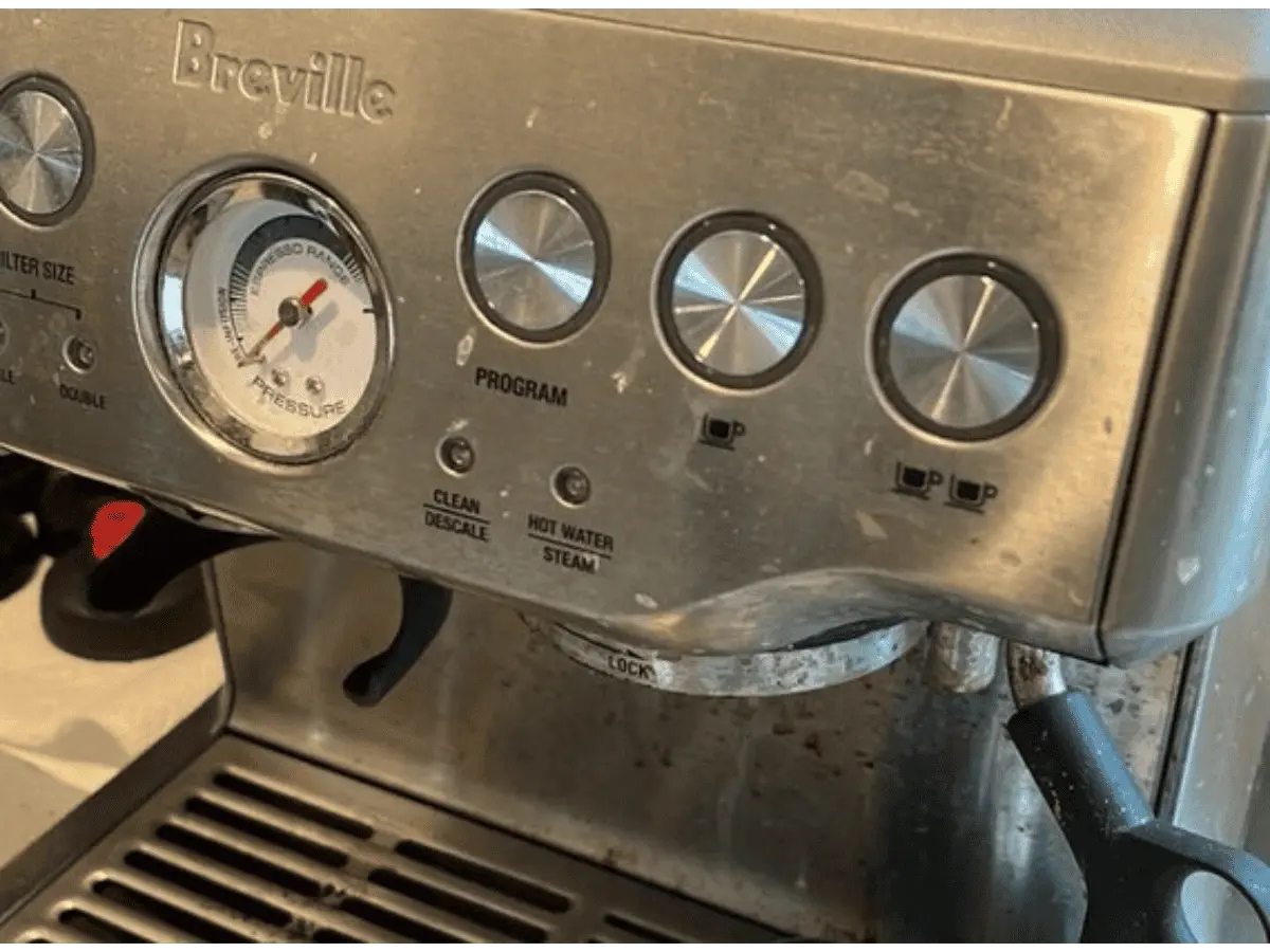 alt="Before photo of a stainless steel espresso machine covered in coffee grounds, milk residue, and grime."