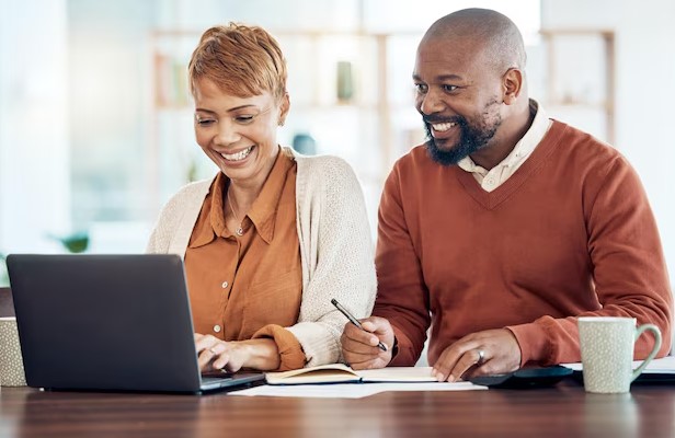 Happy couple reviewing options provided to protect their family.