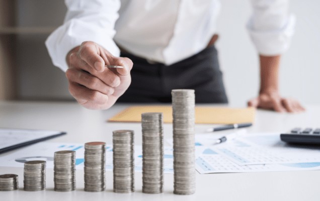 Man stacking coins, showing how every investment counts!