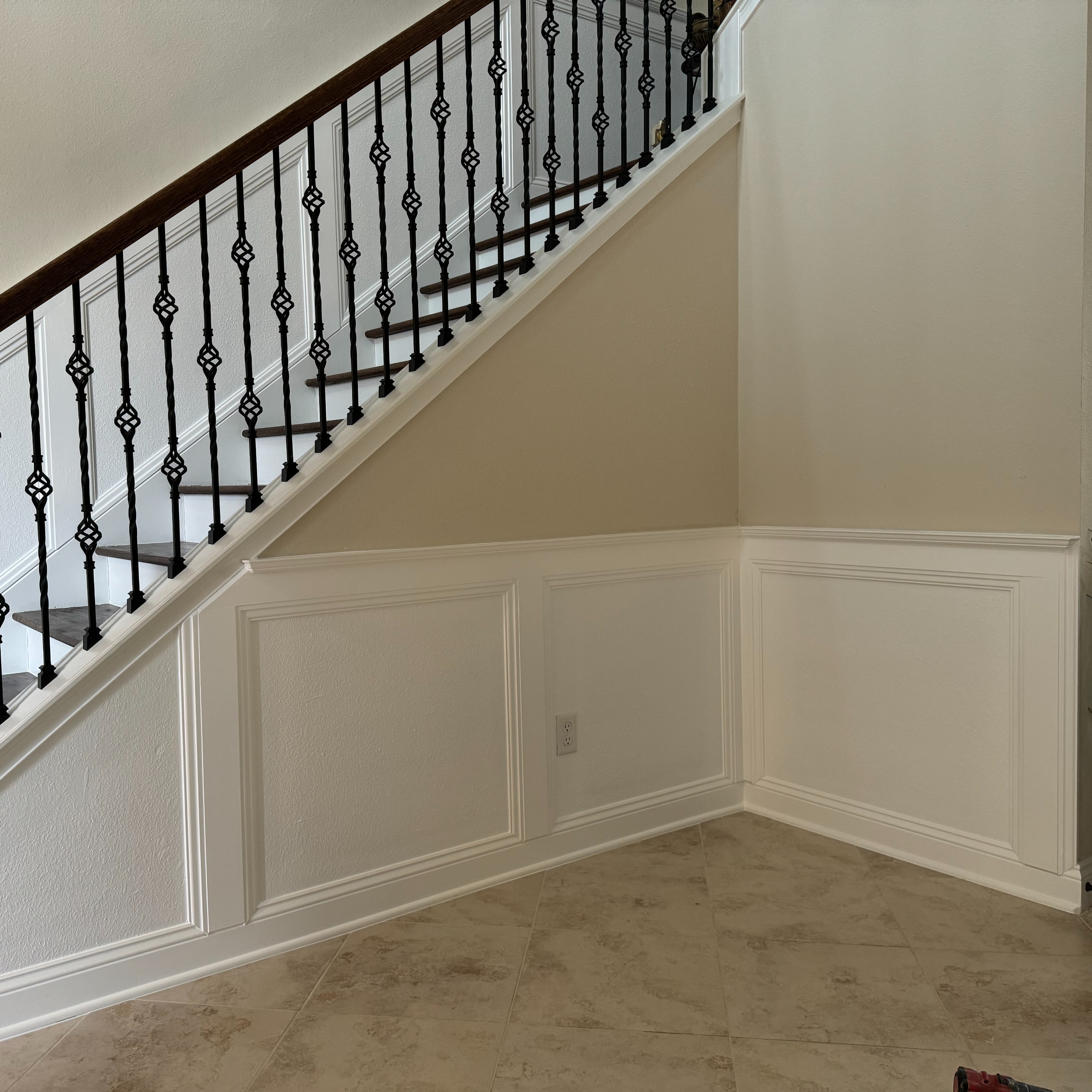 room featuring minor wainscoting and decorative paneling. The subtle woodwork complements the neutral tones, adding elegance without overwhelming the space. room featuring minor wainscoting and decorative paneling. The subtle woodwork complements the neutral tones, adding elegance without overwhelming the space.