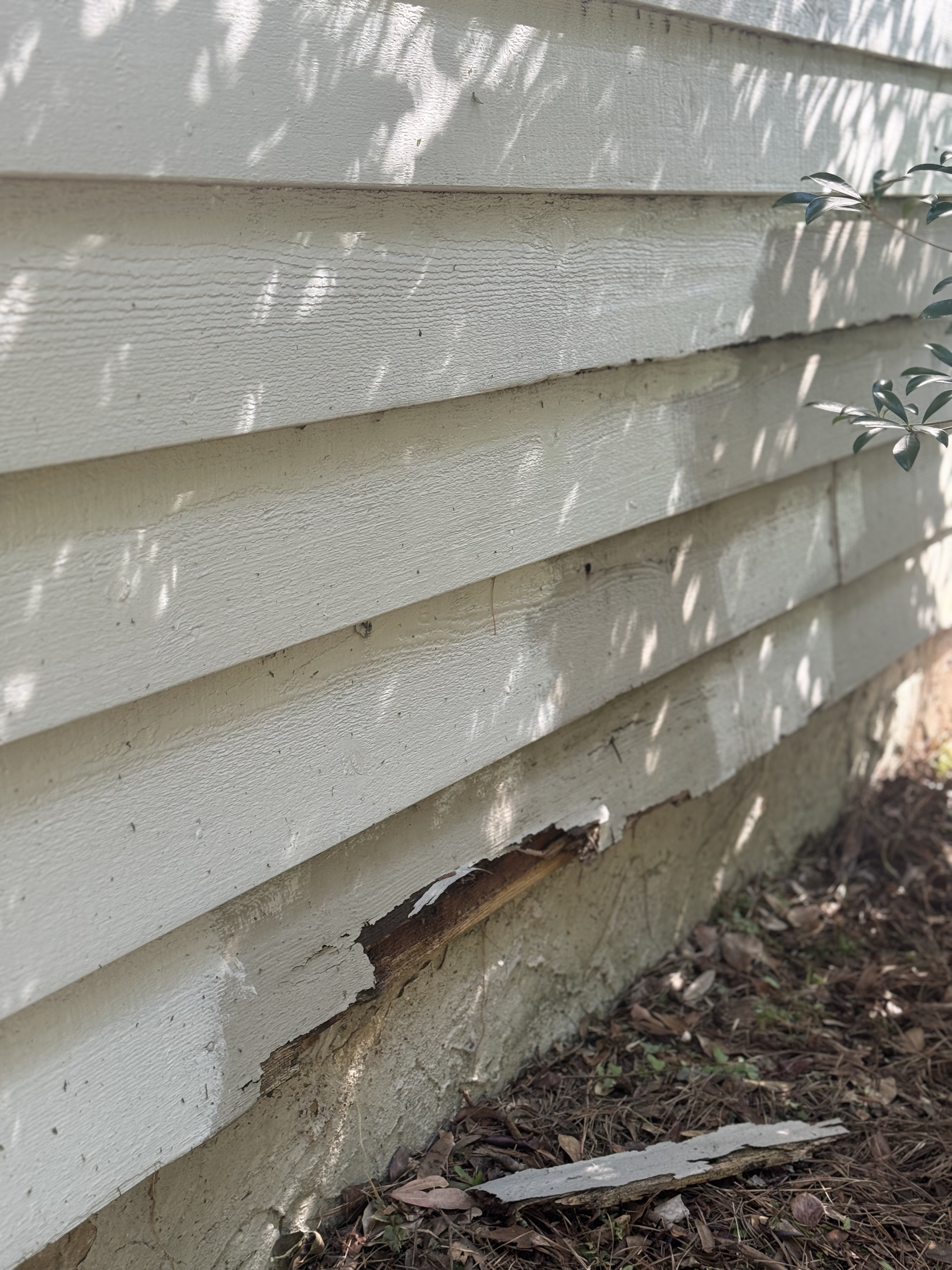 damaged home siding, with visible cracks, warping, and peeling. damaged home siding, with visible cracks, warping, and peeling.