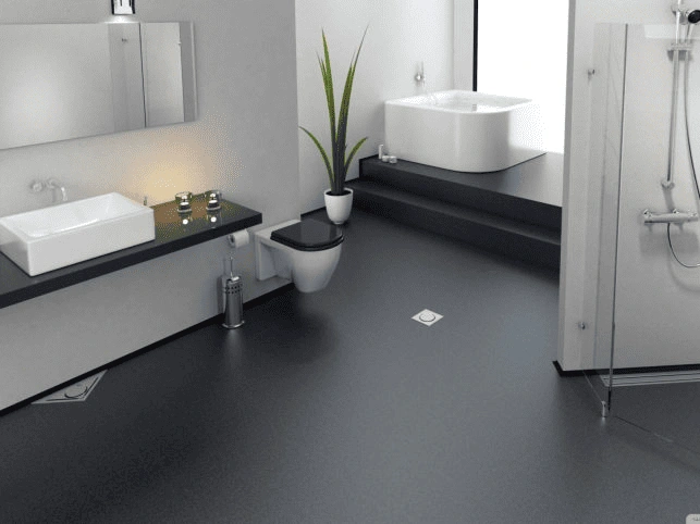 a bathroom remodeling features a modern black countertop, sleek bathtub, and minimalist design.