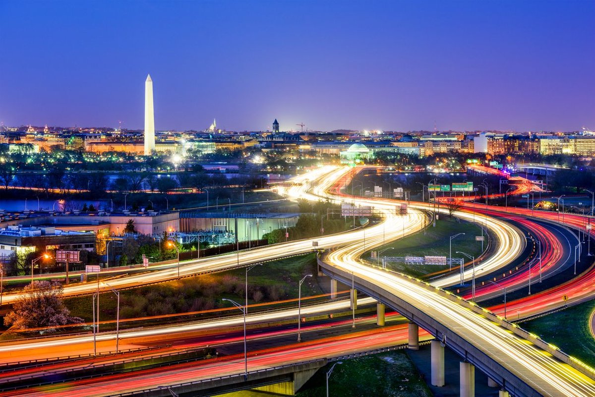 Image of washington highway at night with orange blur of moving cars