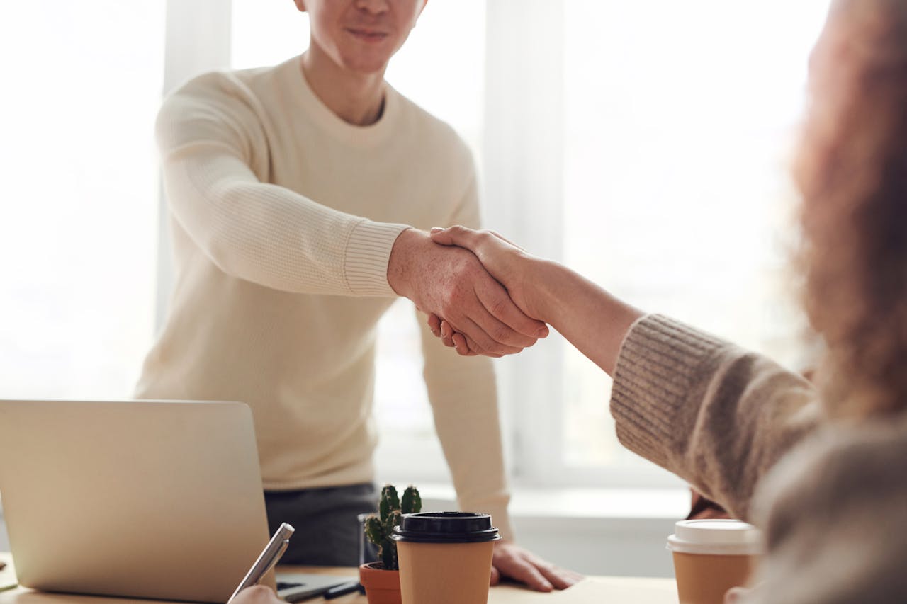 Man and women shaking hands in an office