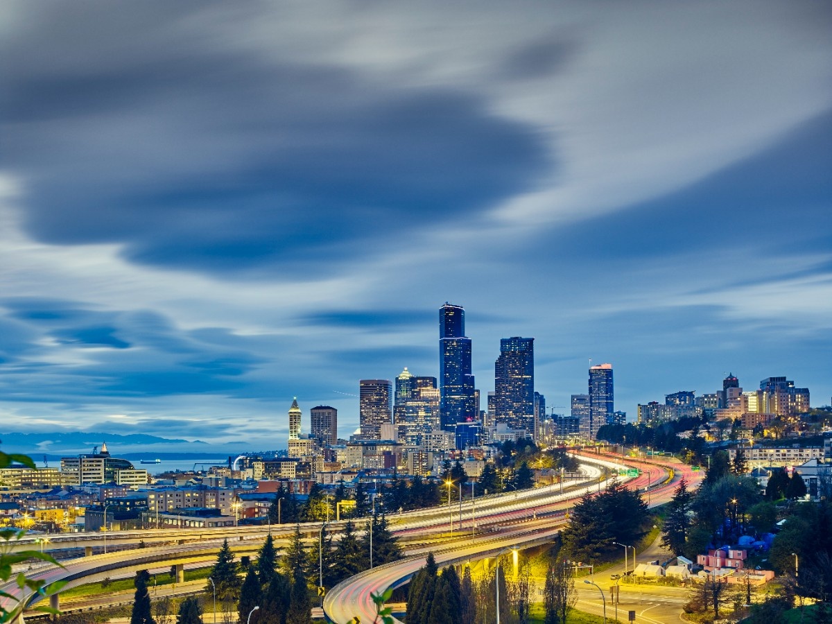 Traffic light trails and cityscape at dusk