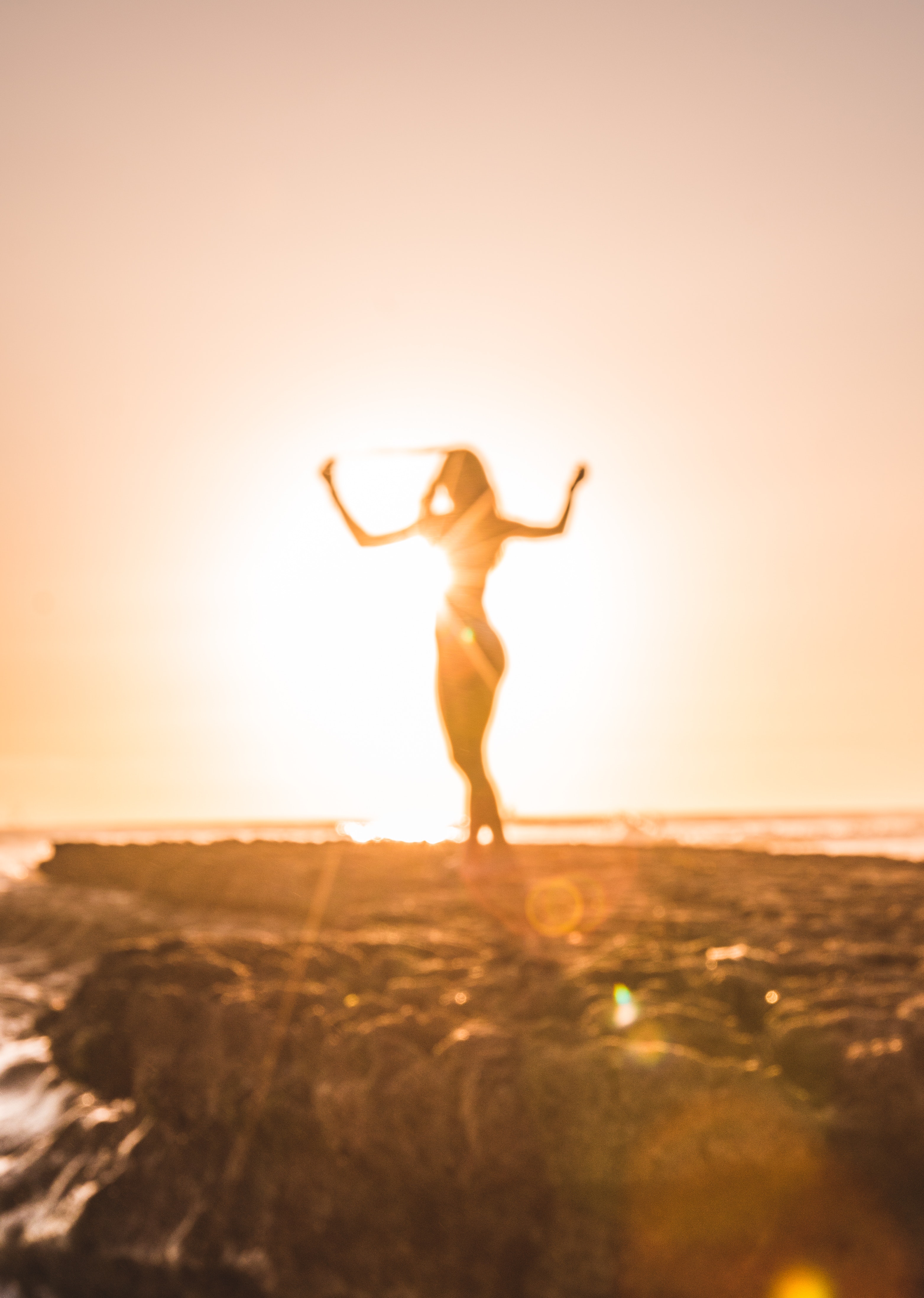 woman dancing free on the beach