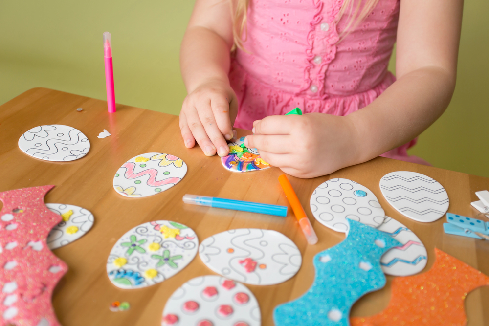 girl decorating paper eggs