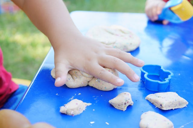 child playing with playdough