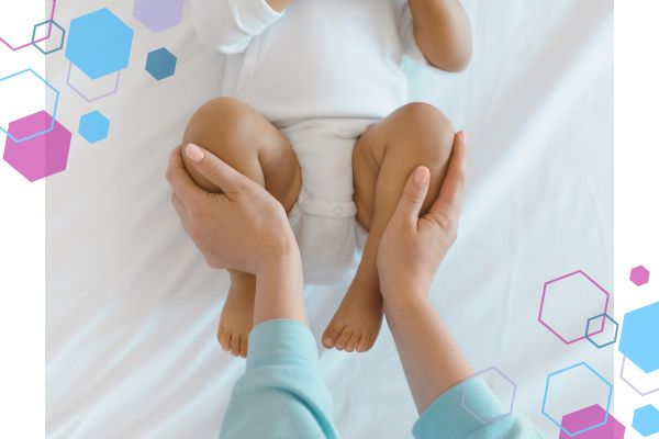 An image of baby's legs with adult hands pushing on their shins, pushing the legs into a sitting position. An image of baby's legs with adult hands pushing on their shins, pushing the legs into a sitting position.