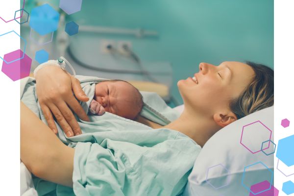 A new mum lies back in bed whilst cuddling her baby on her chest skin-to-skin. The woman has her eyes closed and is smiling, enjoying the absolute joy of birth. A new mum lies back in bed whilst cuddling her baby on her chest skin-to-skin. The woman has her eyes closed and is smiling, enjoying the absolute joy of birth.