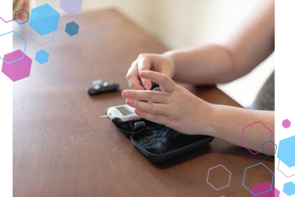 A gestational diabetes blood sugar monitor set on a table with a woman testing her blood sugar levels A gestational diabetes blood sugar monitor set on a table with a woman testing her blood sugar levels