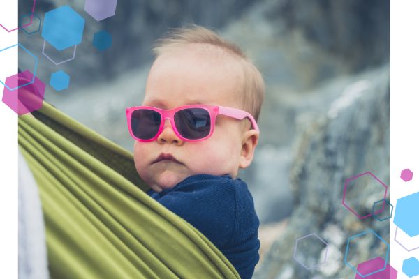CubCare blog post, babywearing in warmer weather. Image is of a baby in a baby sling looking at the camera with a "cool" expression on his face. He is wearing sunglasses for babywearing in summer. CubCare blog post, babywearing in warmer weather. Image is of a baby in a baby sling looking at the camera with a "cool" expression on his face. He is wearing sunglasses for babywearing in summer.
