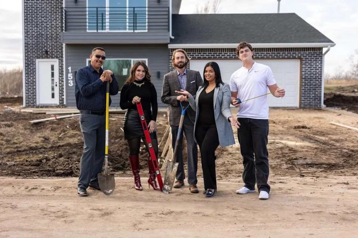 Team standing in front of a newly built home