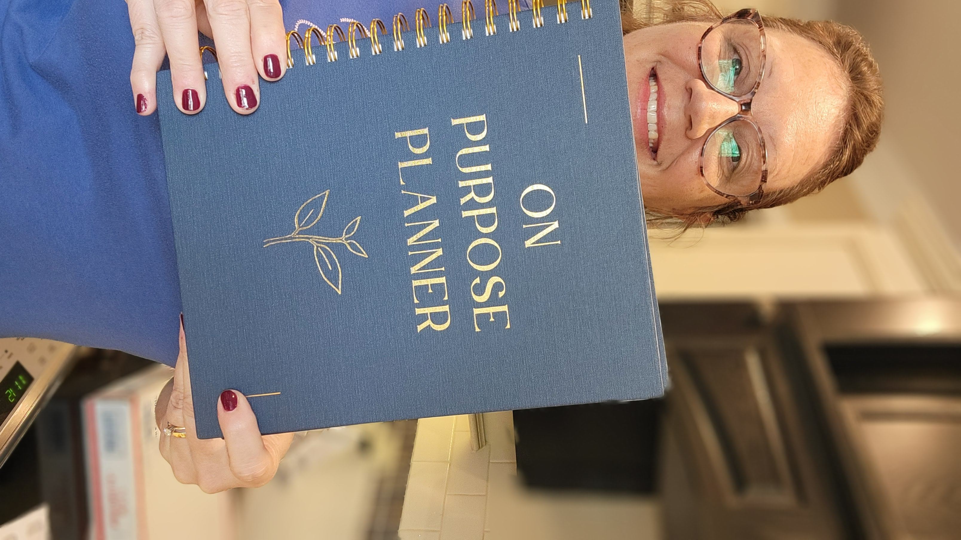 woman holding The On Purpose Planner