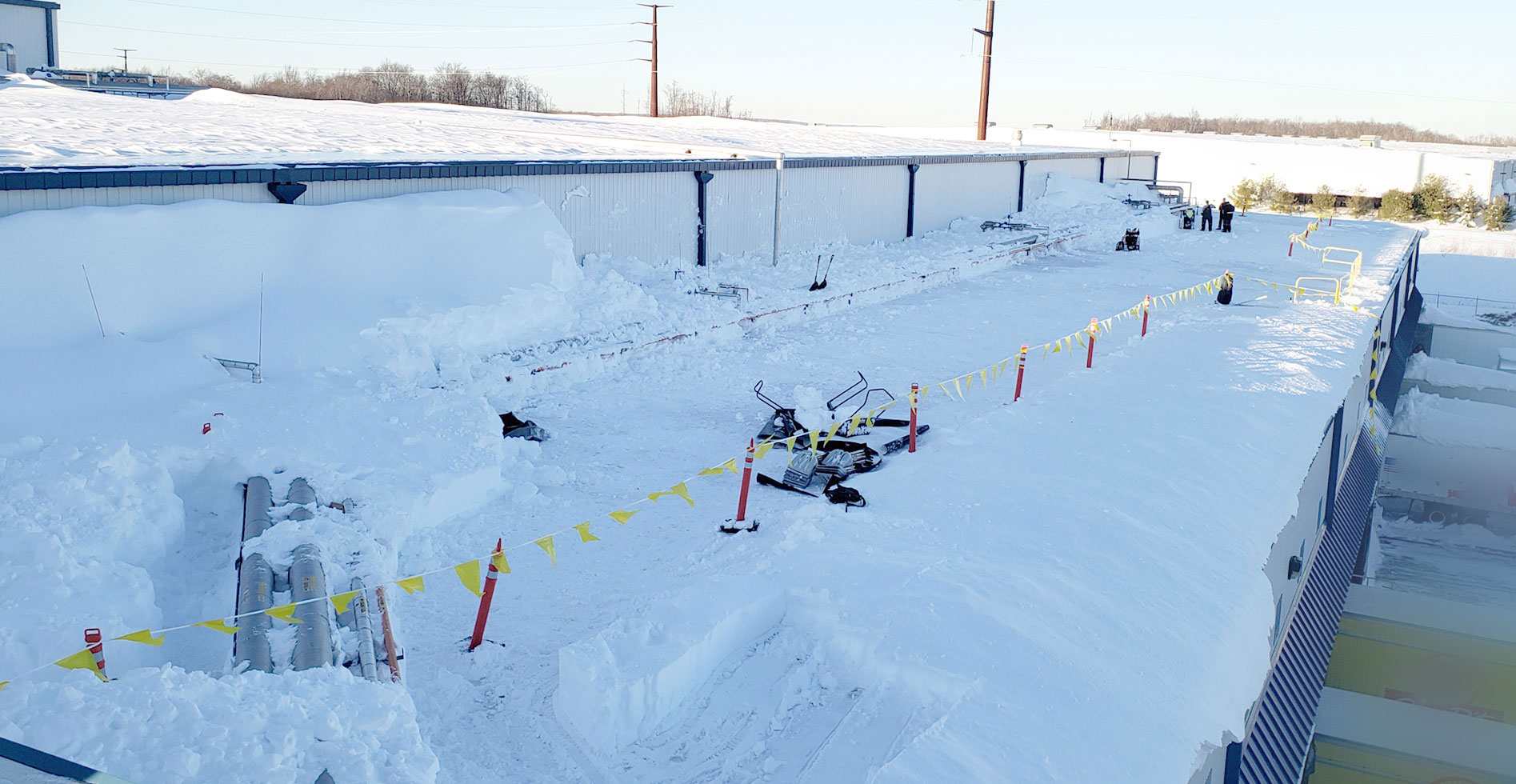Professional team removing snow from a commercial roof in Cambridge, MN Professional team removing snow from a commercial roof in Cambridge, MN
